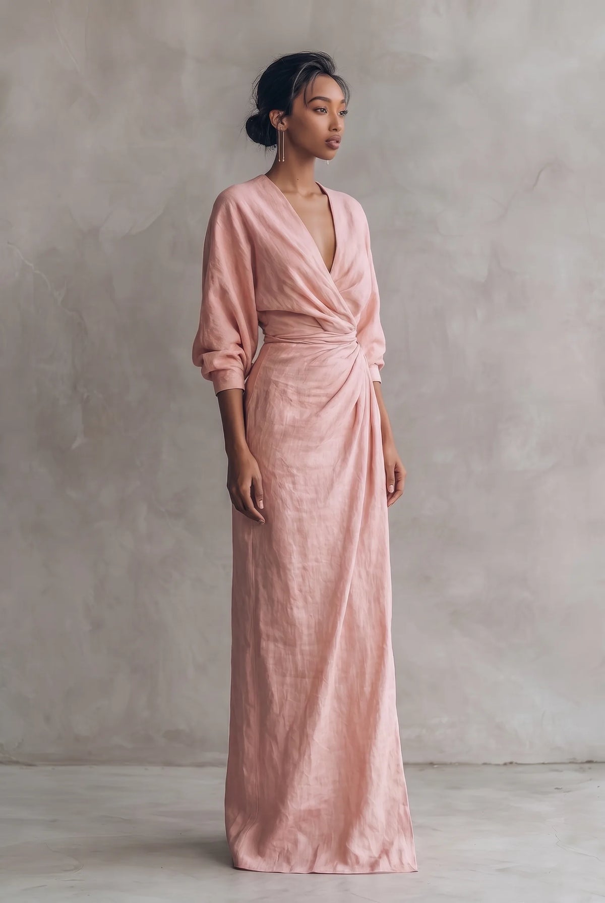 Side angle of the pink linen-blend wrap maxi dress showing the gathered waist knot and column-length skirt