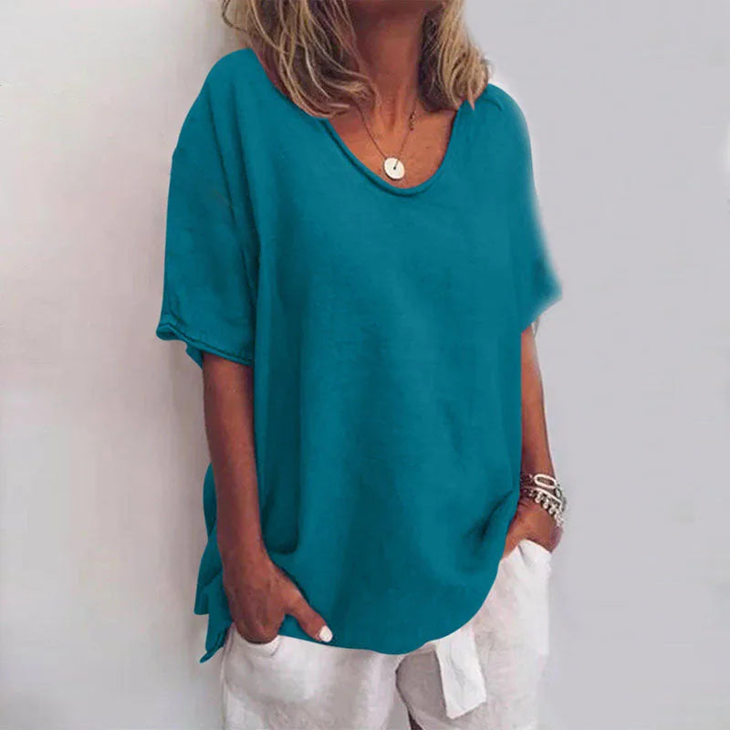 Close-up of the oversized tee in teal, highlighting the lightly textured woven fabric
