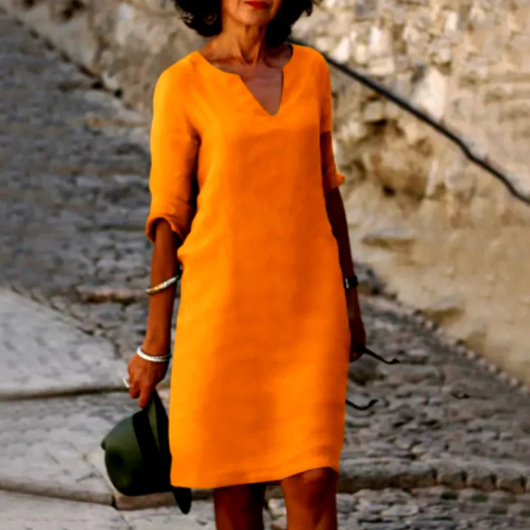 Bright orange textured dress with folded half sleeves and relaxed straight cut, close-up front view