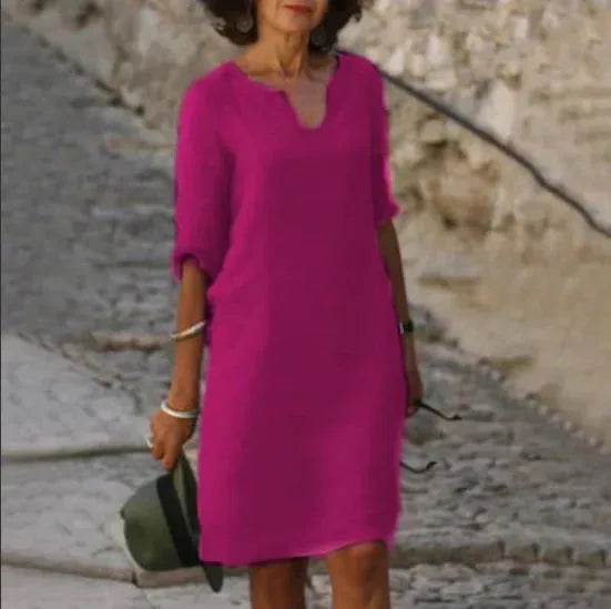 Fuchsia pink dress with notched V-neckline and relaxed straight silhouette, cropped front view