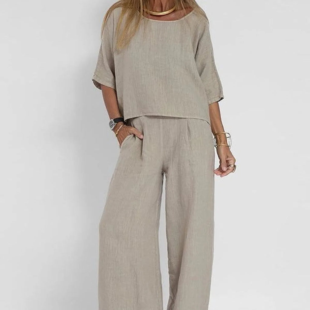 Close-up of a woman in the grey marle boxy top and wide leg pants, hand in pocket, showing fabric texture and relaxed fit