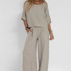 Close-up of a woman in the grey marle boxy top and wide leg pants, hand in pocket, showing fabric texture and relaxed fit