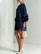 Side angle of the white dress highlighting the raglan sleeve seam and oversized floral cuff