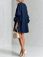 Back three-quarter view of the white textured dress showing the smooth back panel and sleeve volume