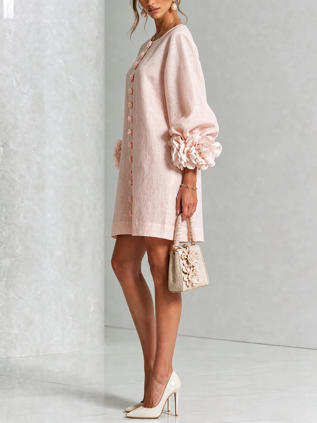 Full-length front view of the white mini dress paired with cream patent pointed-toe pumps