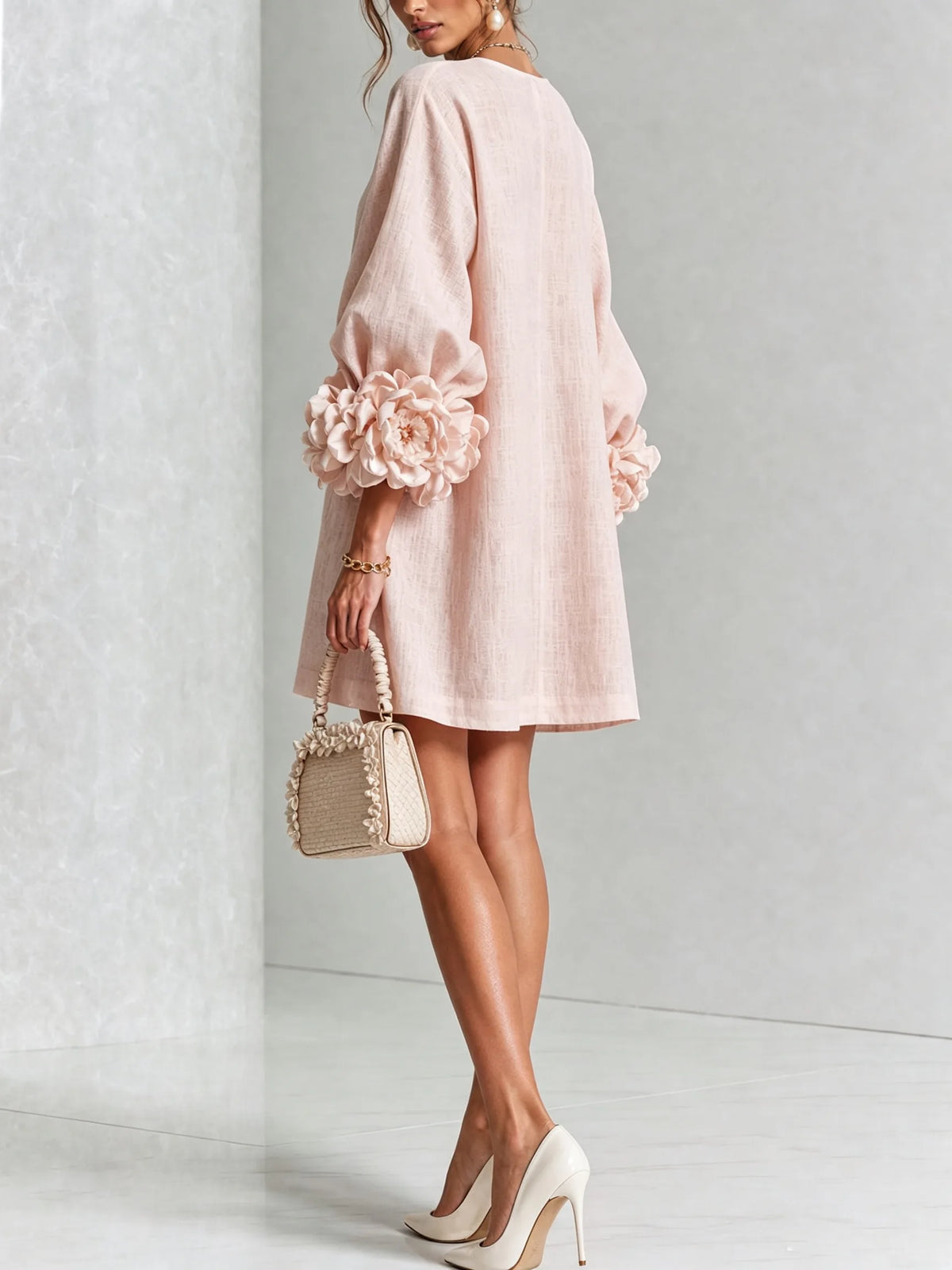 Close-up of the vertical row of floral buttons from neckline to hem on the white textured dress