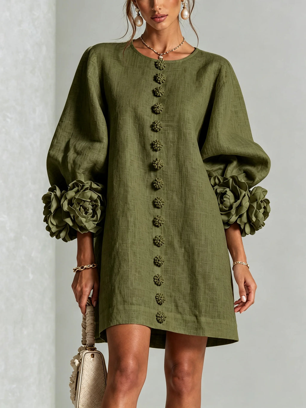 Front view of the olive green textured mini dress with voluminous floral cuffs and matching button trim