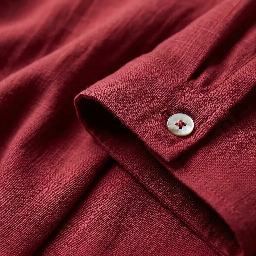 Flat lay of a relaxed-fit linen short-sleeve shirt highlighting the breathable woven fabric and clean silhouette