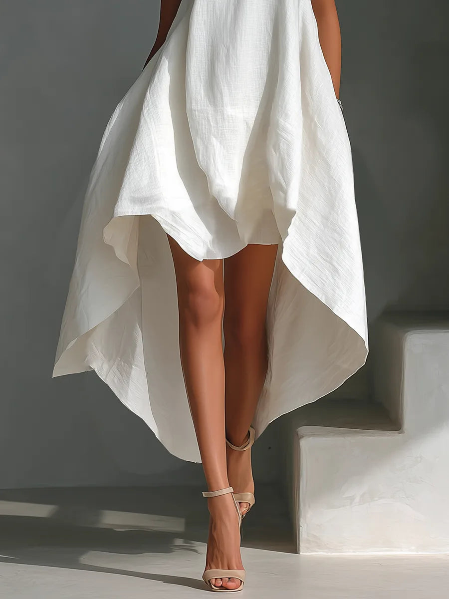 Close-up detail of the white linen fabric texture across the bodice and flowing skirt