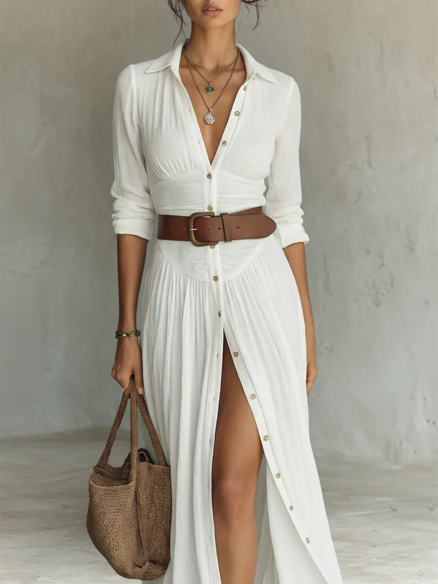 Front view of the white long-sleeve shirt dress with deep V neckline, layered necklaces and brown leather belt