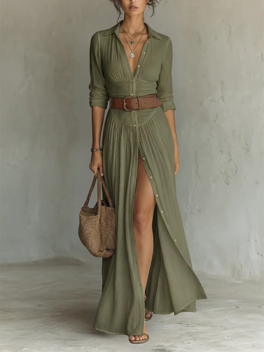 Olive green maxi shirt dress with button placket, brown leather belt and flowing pleated skirt with side slit