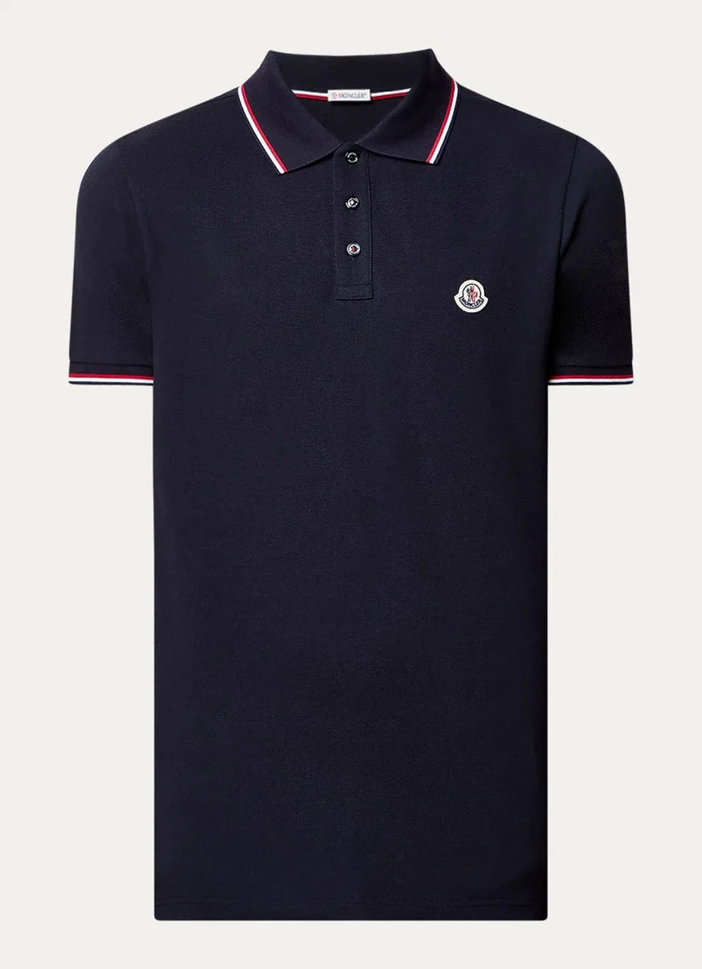 Navy polo shirt with red and white tipped collar and cuffs, button placket and chest logo patch, laid flat