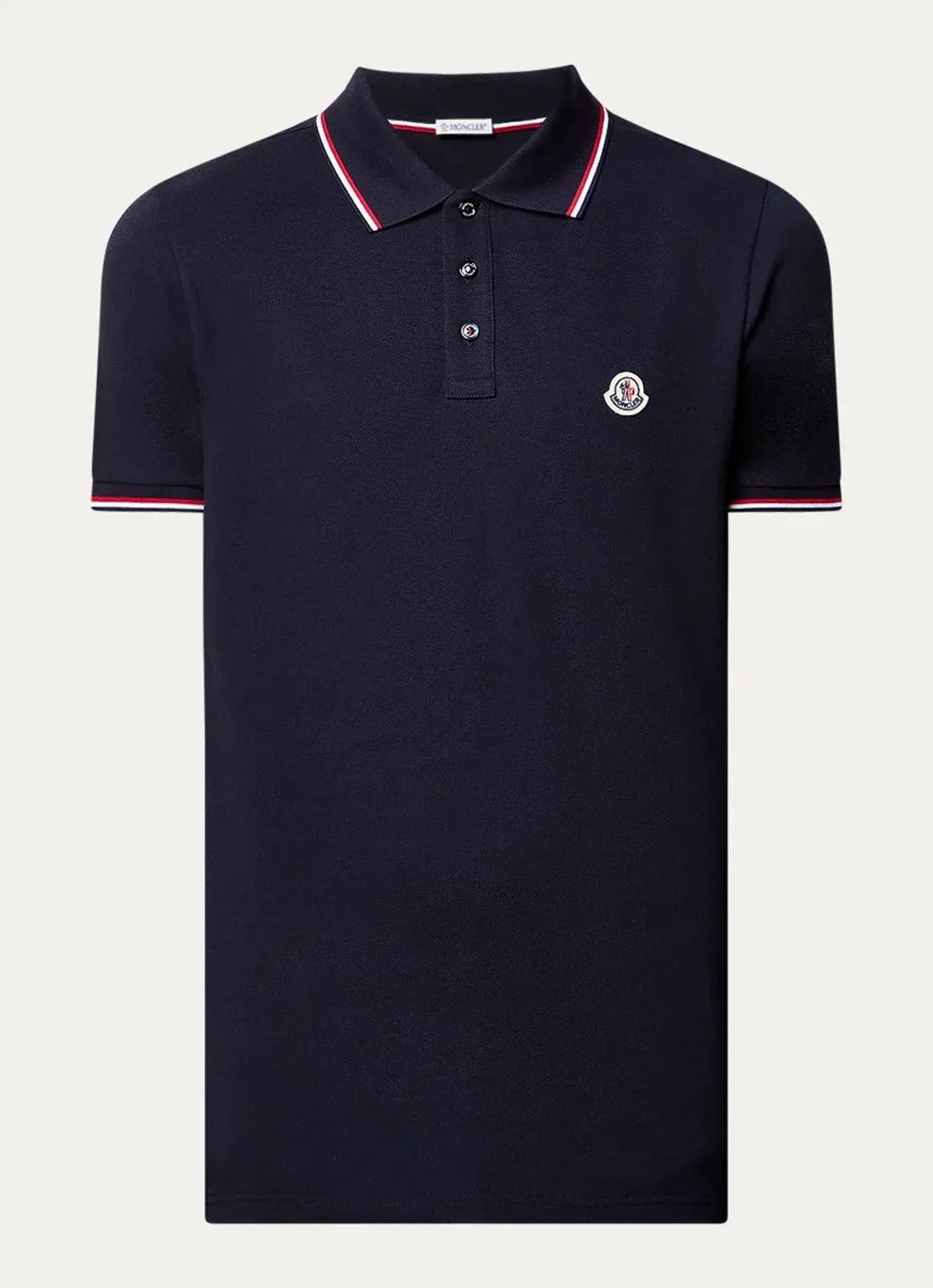 Navy polo shirt with red and white tipped collar and cuffs, button placket and chest logo patch, laid flat