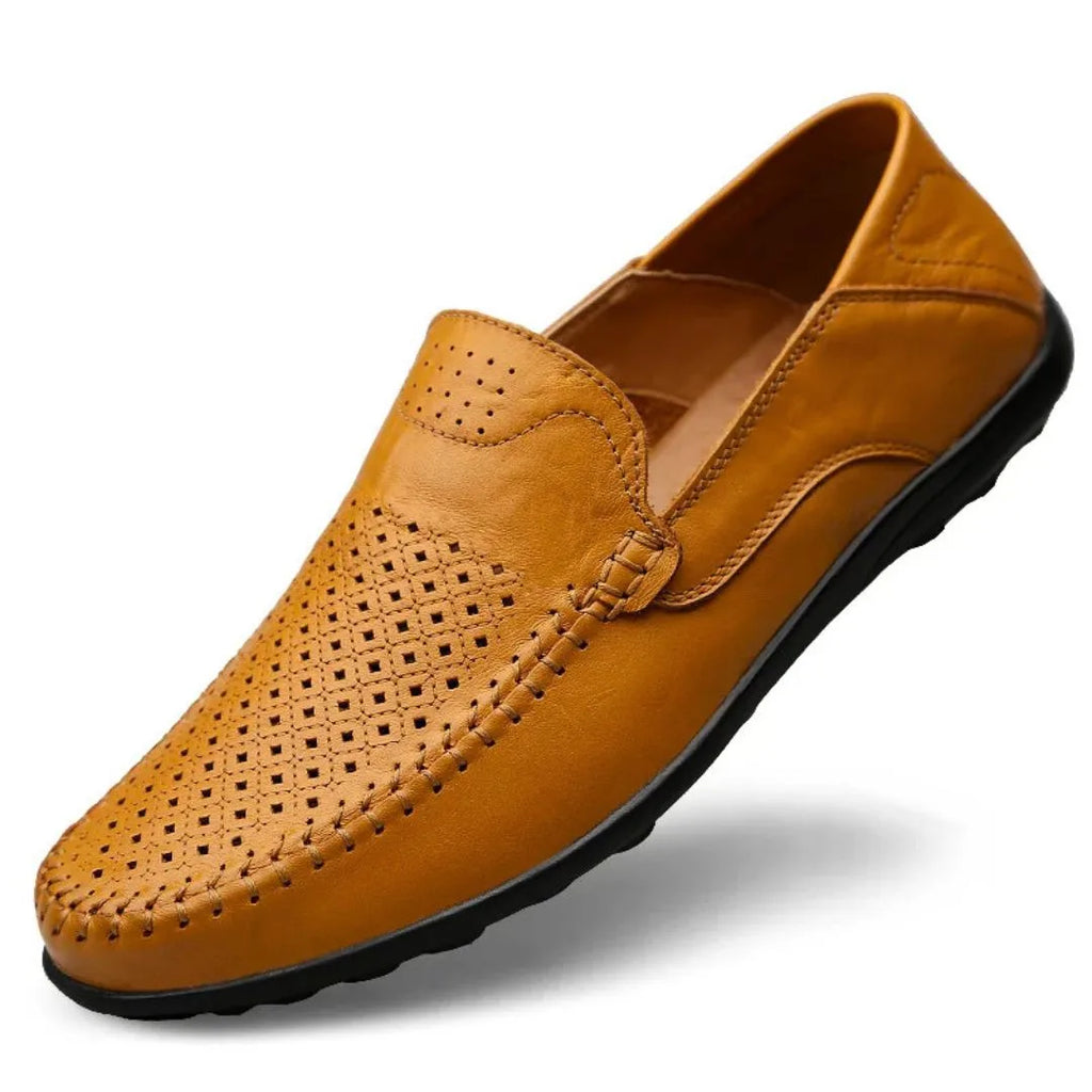 Three-quarter view of a tan leather loafer with diamond laser-cut perforations across the toe