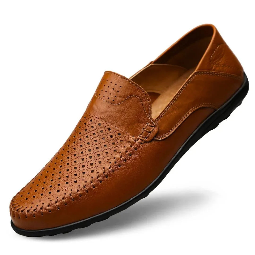 Angled front view of a brown leather loafer highlighting the woven stitch detail near the vamp