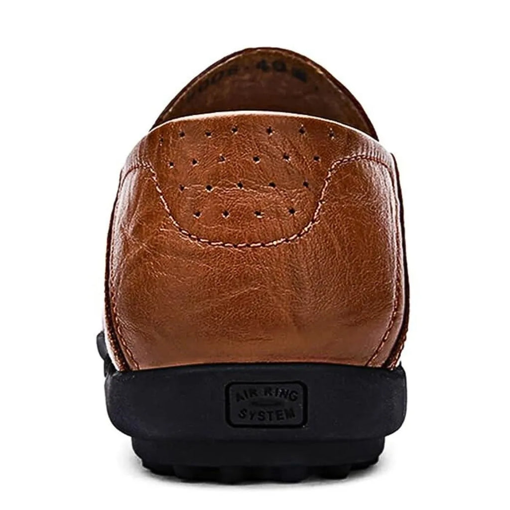 Close-up back view of a brown loafer heel with perforated air vents and reinforced stitching