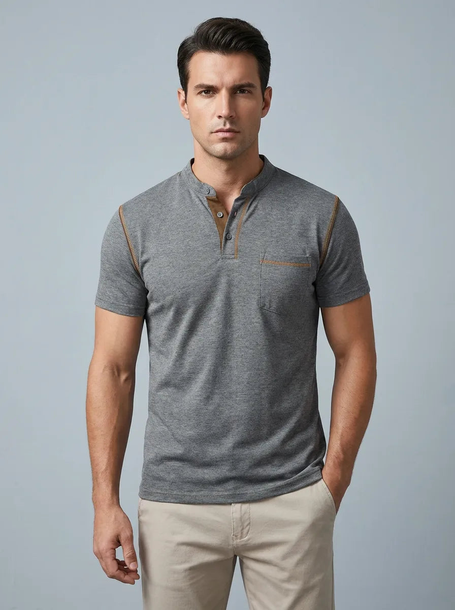Front view of a man wearing a grey henley polo with mandarin collar, button placket and contrast tan trim at the shoulders