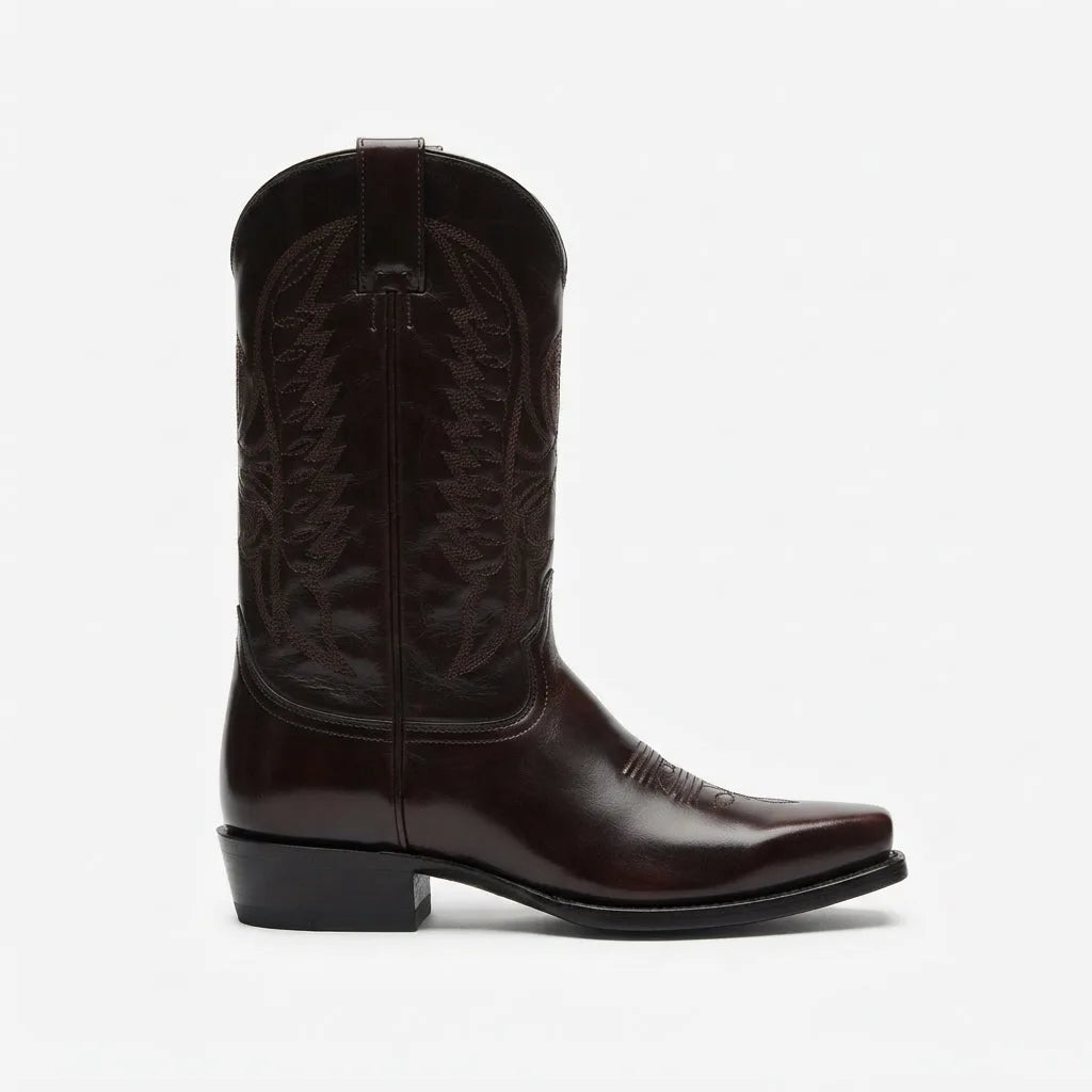 Side profile of a dark brown leather cowboy boot with tonal stitched shaft and a classic block heel