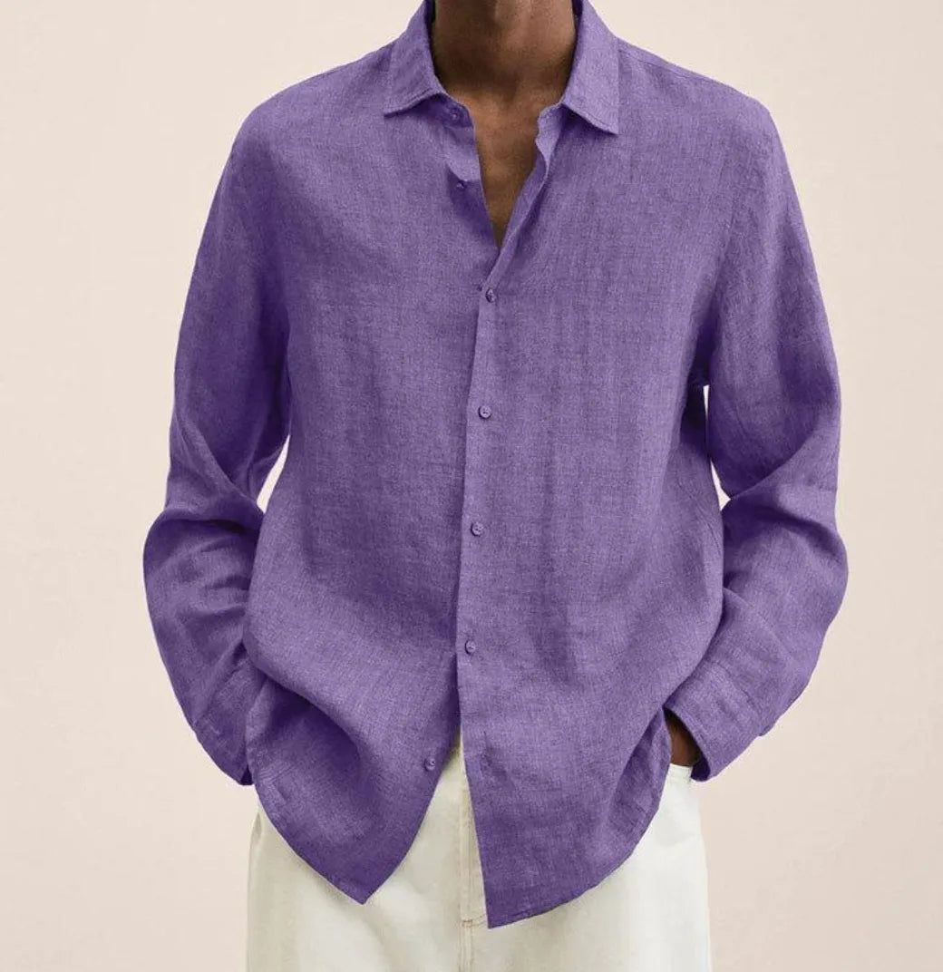 Close-up front view of a man wearing a purple linen long-sleeve shirt with open collar, unbuttoned at the top