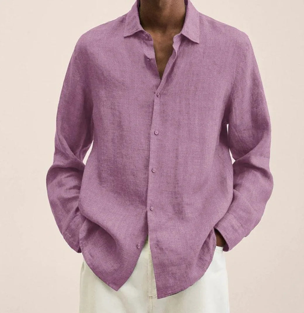 Close-up of the curved shirt hem falling over white trousers, showing the relaxed silhouette