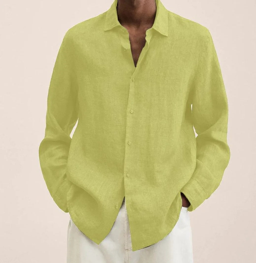 Front view of a linen shirt worn untucked with hands in pockets, showing the overall relaxed fit