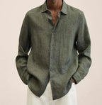 Detail shot of the linen shirt fabric weave and button stitching against a neutral background