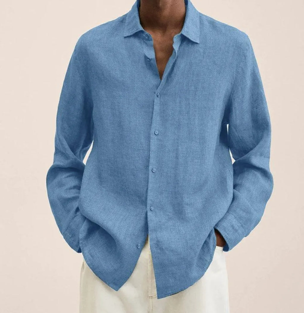 Close-up front view of a denim-blue linen shirt highlighting the natural fabric weave and curved hem