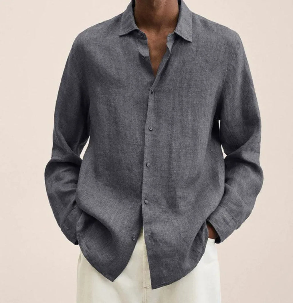 Close-up of the collar and button placket on a linen shirt, showing stitch detail and fabric drape