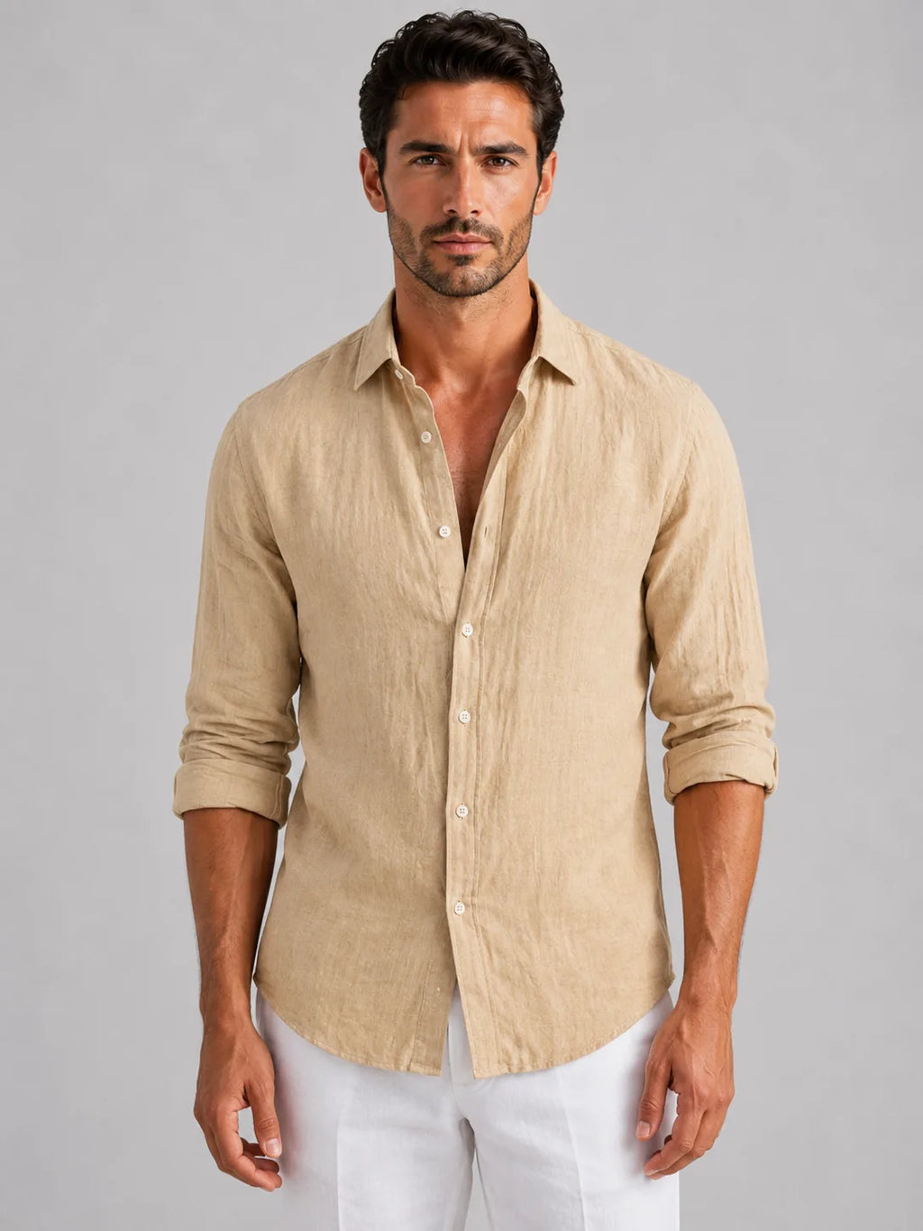 Man wearing a beige linen-look button-up shirt with rolled sleeves, buttoned down over white trousers