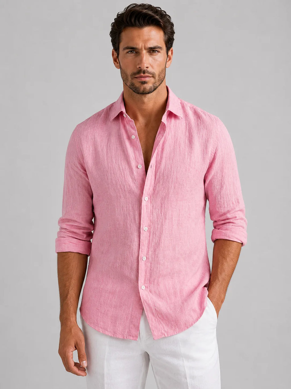 Man wearing a pink linen-look button-up shirt with rolled sleeves, buttoned over white trousers, front view