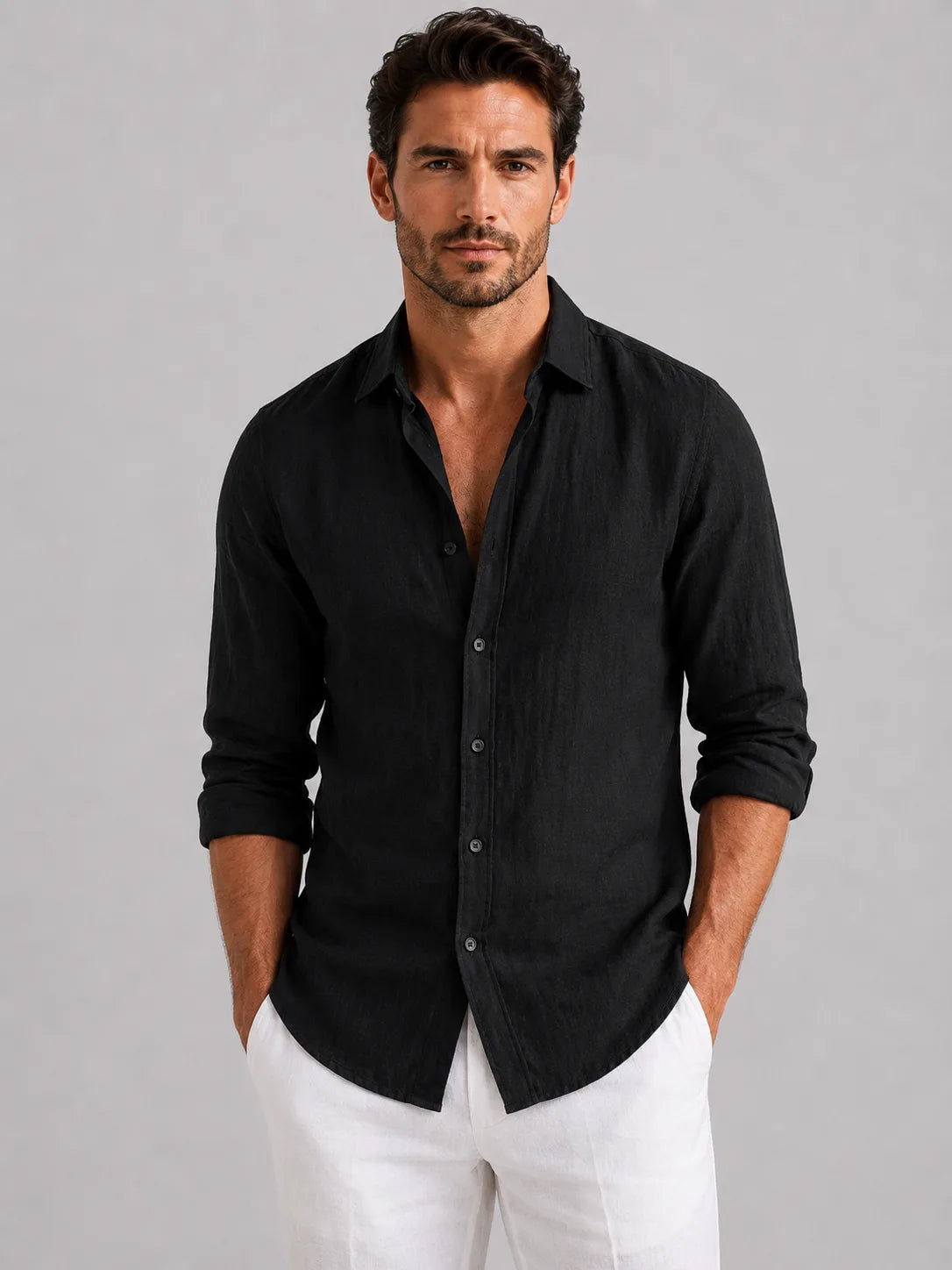 Front view of a man in an open-collar linen-look shirt showing the point collar and mother-of-pearl style buttons