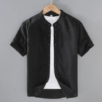 Ivory linen short sleeve shirt on a hanger highlighting the textured woven fabric and clean back yoke