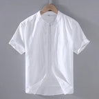 White linen short sleeve shirt on a hanger showing the stand collar and rounded curved hem