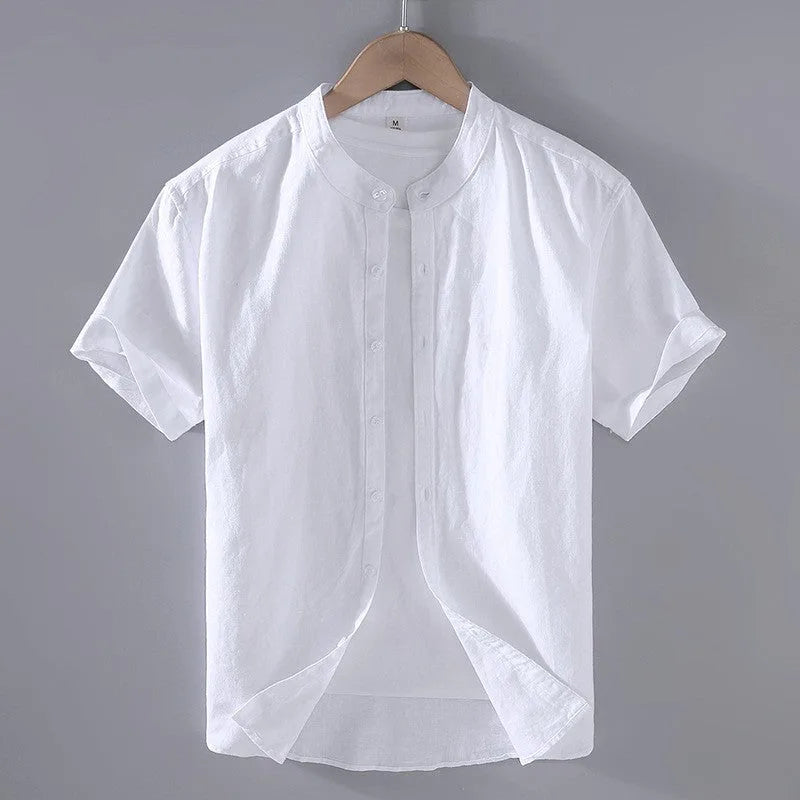 White linen short sleeve shirt on a hanger showing the stand collar and rounded curved hem