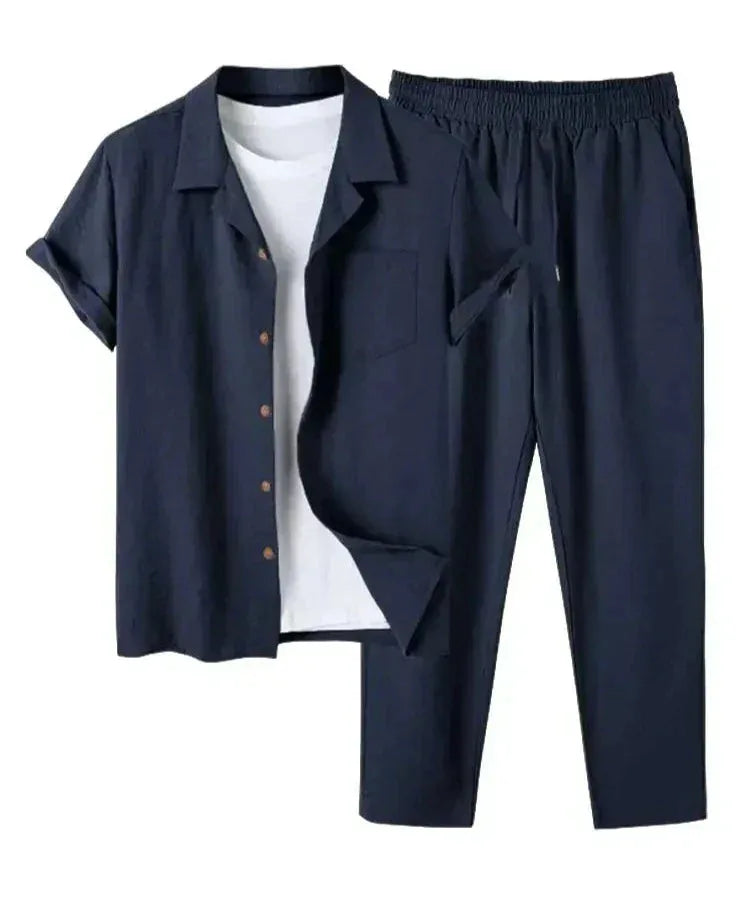 Navy blue linen shirt and trouser two-piece set with wooden buttons, laid flat over a white t-shirt