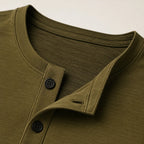 Close-up of henley collar and button placket showing dark buttons and ribbed trim detail