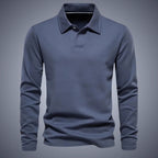 Slate blue long-sleeve polo shirt, front view, showing ribbed collar, button placket and embroidered logo detail