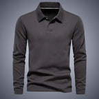 Dark grey long-sleeve polo shirt, front view, showing the structured collar and subtle chest embroidery