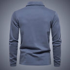 Back view of slate blue long-sleeve polo shirt, showing the smooth yoke and clean seam finishing