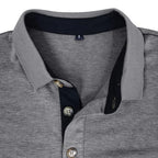 Man standing with hands near pockets wearing the olive green long-sleeve polo shirt