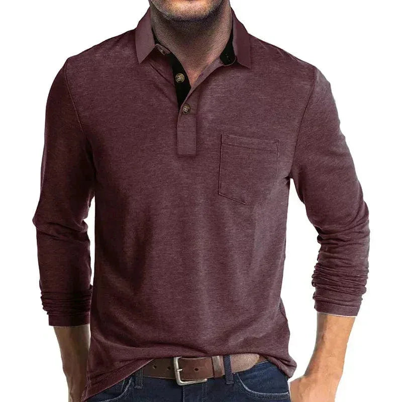 Man modelling a muted wine-red long-sleeve polo shirt with pocket and tucked-in styling with belt