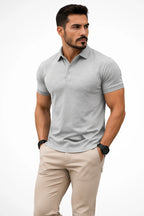 Man wearing a grey marle short-sleeve polo shirt, showing the fabric texture and tailored muscle-fit cut