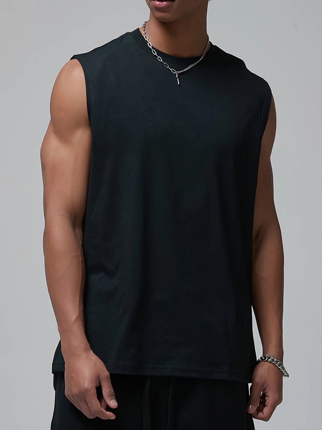 Close-up front view of a man in a black sleeveless tank top showing the crew neckline and relaxed fit