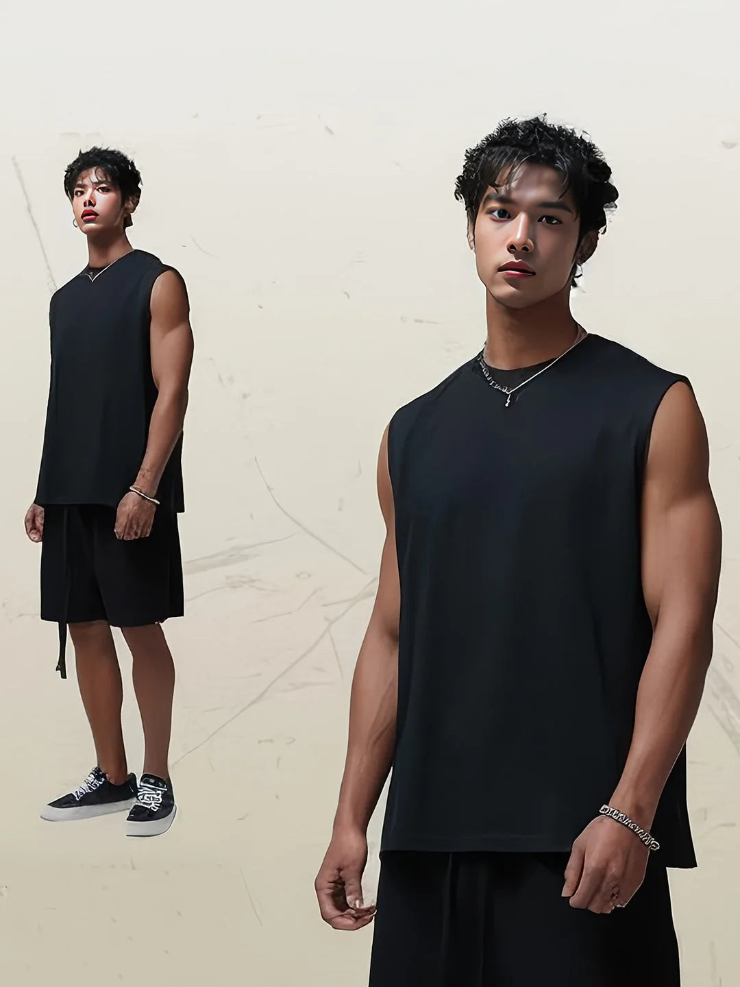 Two models styled in black sleeveless tank tops paired with matching shorts and sneakers, full outfit view