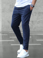 Side view of navy blue slim fit chino pants highlighting the slim tapered silhouette and clean seam detail.