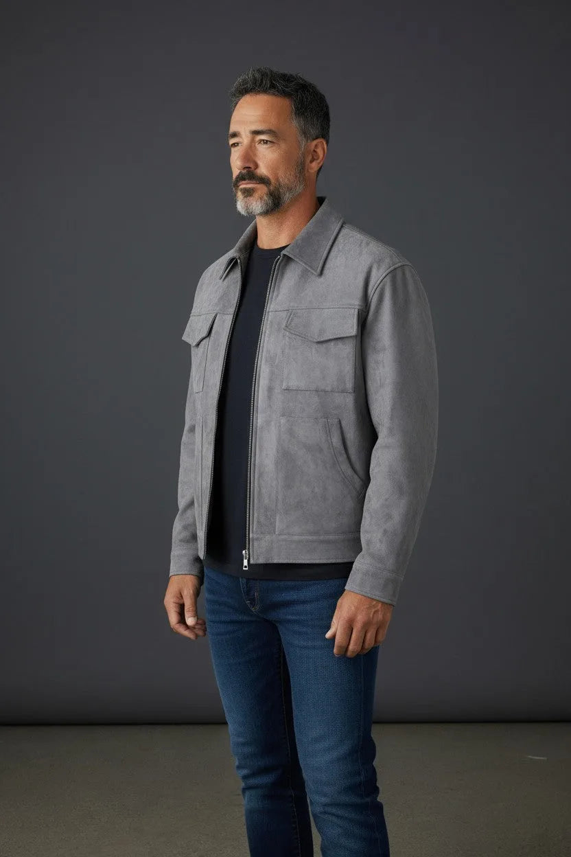 Side profile of a grey suede-effect trucker jacket worn open over a navy tee, showing collar and chest pockets.