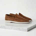 Close-up of the suede texture on the vamp of a light grey loafer