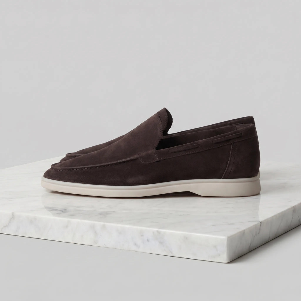 Close-up of the heel stitching detail on a light grey suede loafer