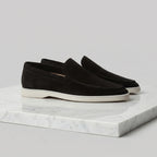 Close-up of the toe stitching and suede nap on a dark brown loafer
