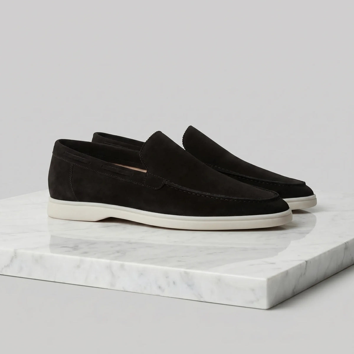 Close-up of the toe stitching and suede nap on a dark brown loafer